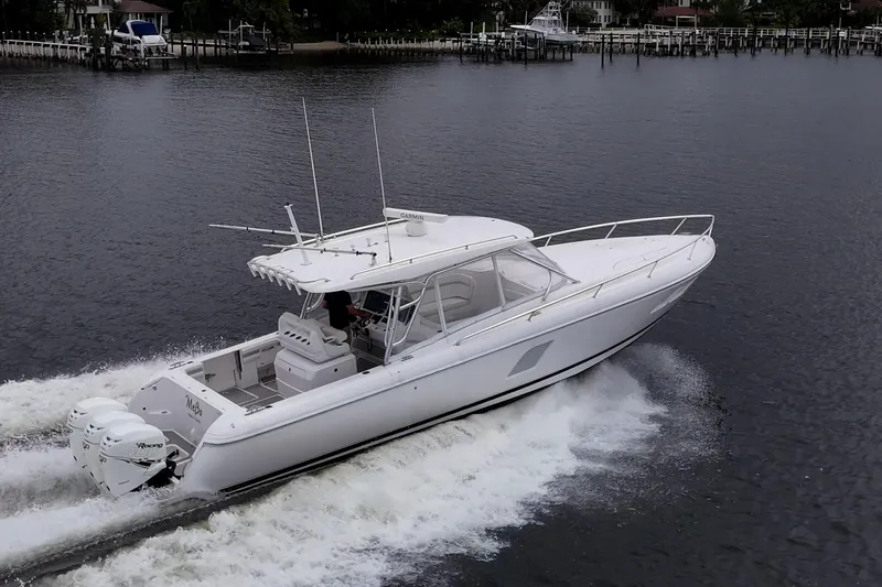  Yacht Photos Pics 2019 Intrepid 407 Cuddy cruising on calm waters, showcasing sleek design and powerful engines.