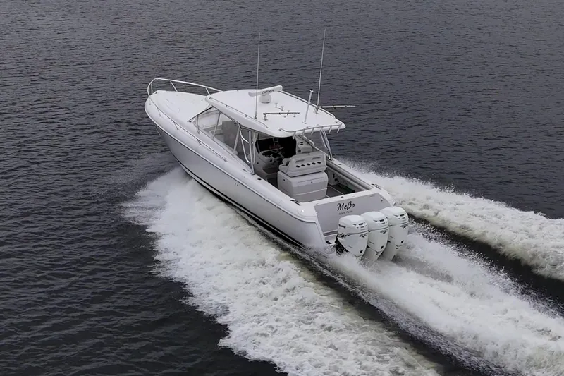  Yacht Photos Pics 2019 Intrepid 407 Cuddy cruising on water with triple outboard engines.