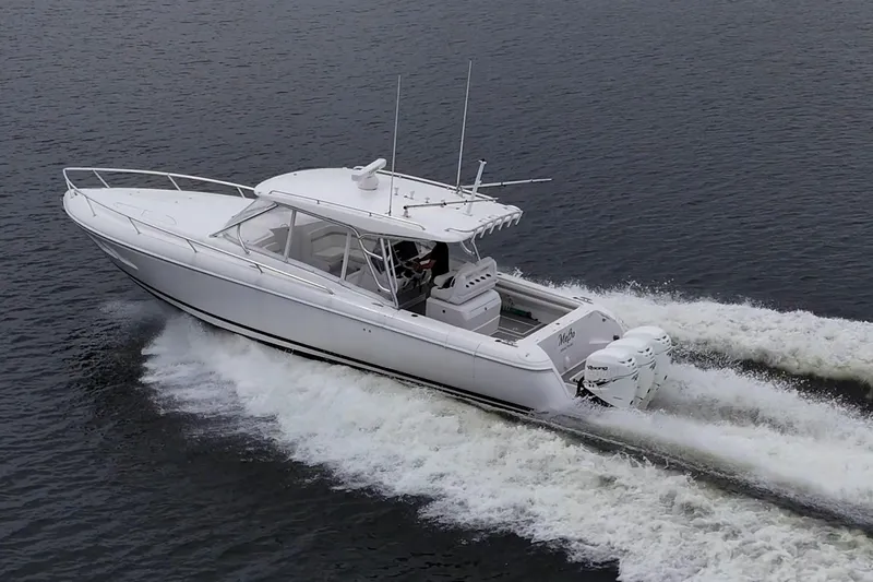  Yacht Photos Pics 2019 Intrepid 407 Cuddy cruising on water, showcasing sleek design and powerful engines.
