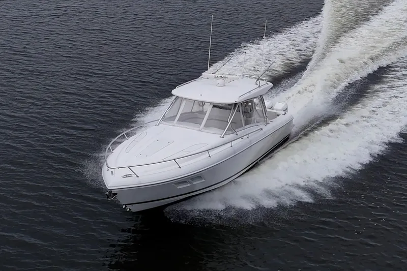  Yacht Photos Pics 2019 Intrepid 407 Cuddy cruising on open water, creating a dynamic wake.
