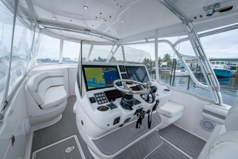  Yacht Photos Pics 2019 Intrepid 407 Cuddy boat cockpit with modern navigation system and luxurious seating.