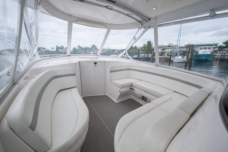  Yacht Photos Pics 2019 Intrepid 407 Cuddy interior with sleek white seating and panoramic windows.