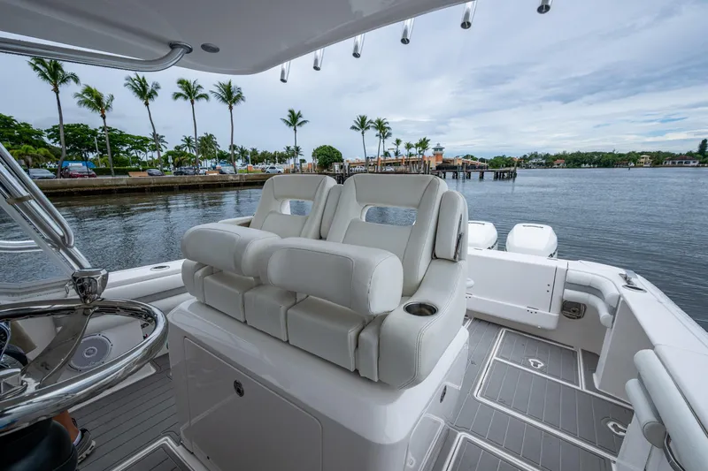  Yacht Photos Pics 2019 Intrepid 407 Cuddy boat interior with plush seating and scenic waterfront view.