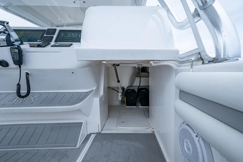  Yacht Photos Pics 2019 Intrepid 407 Cuddy interior with control panel and storage area.