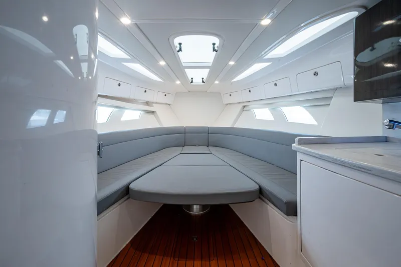  Yacht Photos Pics Luxurious interior of 2019 Intrepid 407 Cuddy boat with modern seating and cabinetry.
