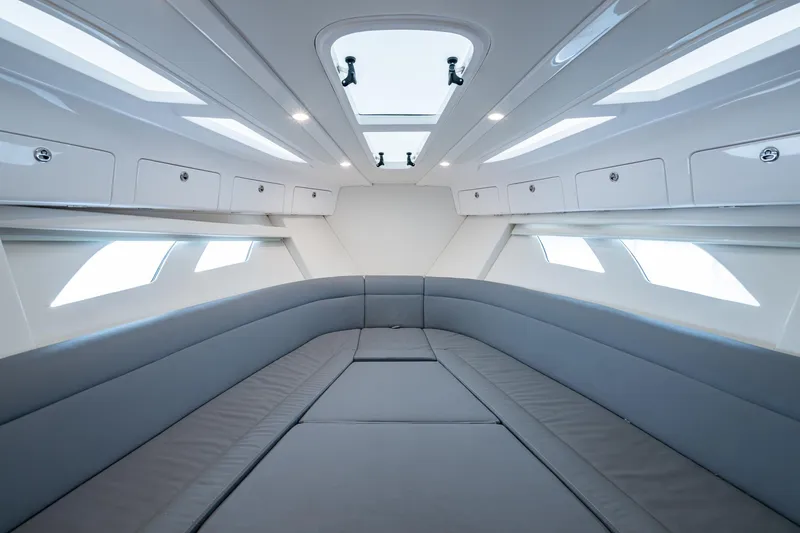 Yacht Photos Pics Luxurious interior of 2019 Intrepid 407 Cuddy boat with sleek seating and skylights.