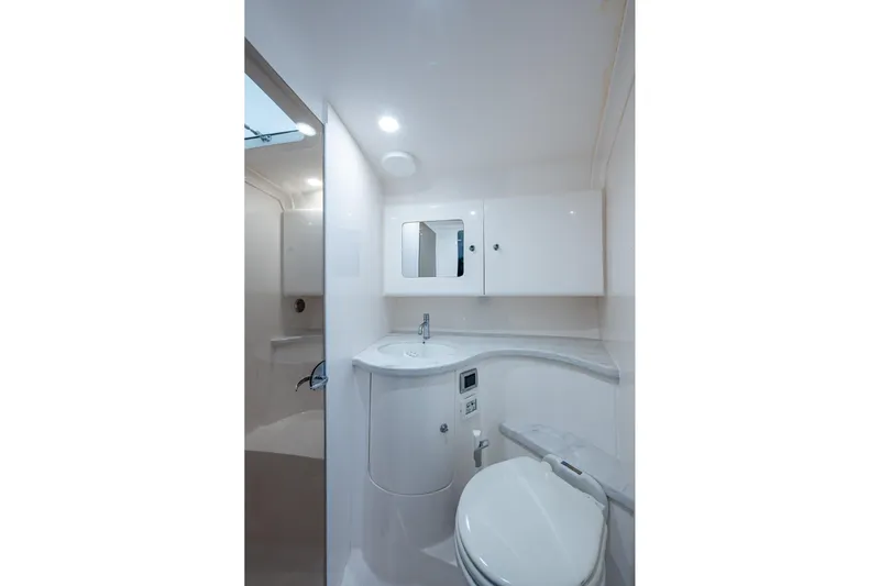  Yacht Photos Pics 2019 Intrepid 407 Cuddy boat bathroom with modern fixtures and sleek design.