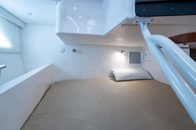  Yacht Photos Pics 2019 Intrepid 407 Cuddy cabin interior with bed, pillow, and reading light.