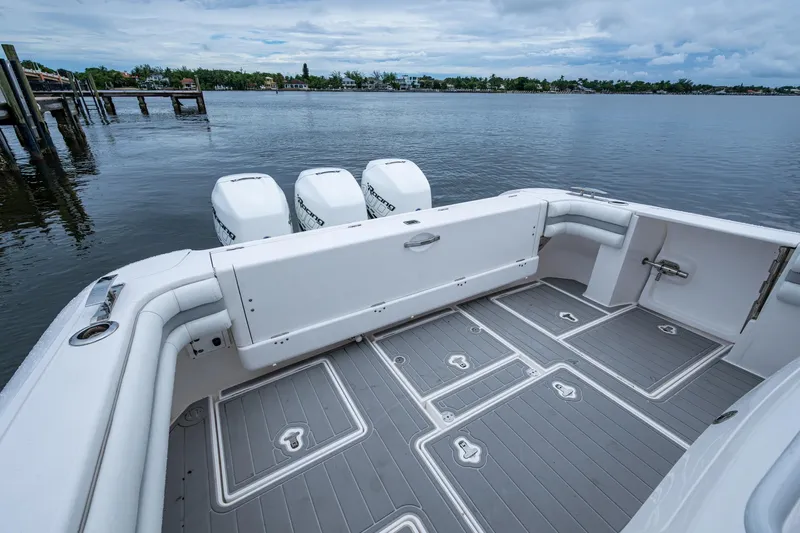  Yacht Photos Pics 2019 Intrepid 407 Cuddy boat with spacious deck and triple outboard engines on calm water.