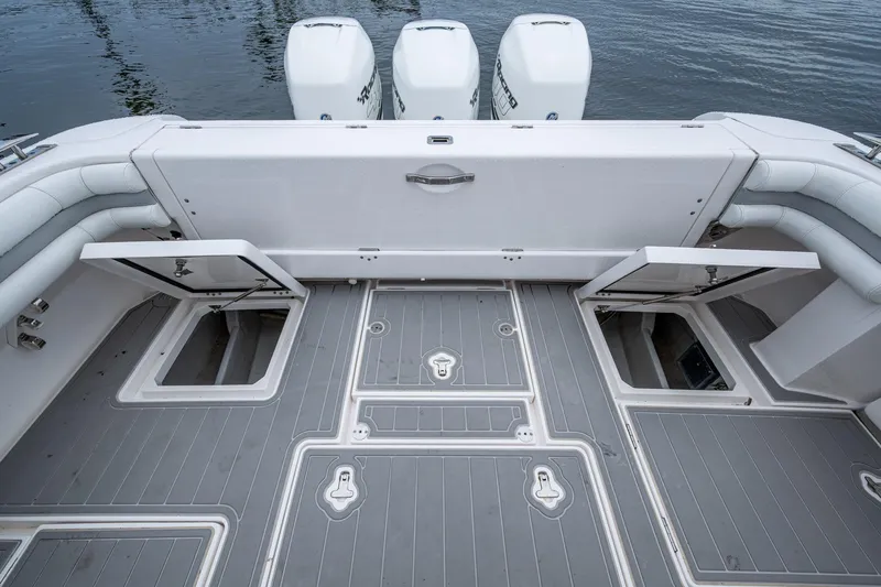  Yacht Photos Pics 2019 Intrepid 407 Cuddy boat deck with storage compartments and triple outboard engines.