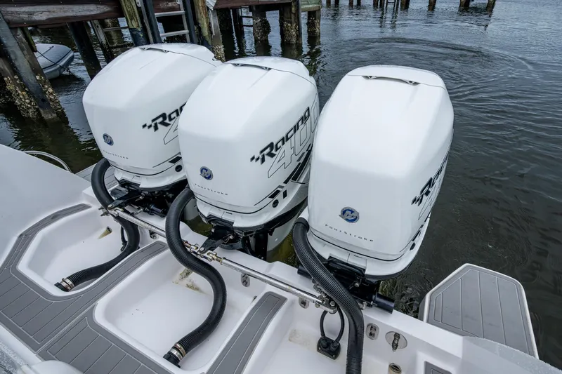  Yacht Photos Pics Triple outboard engines on a 2019 Intrepid 407 Cuddy boat at a dock.
