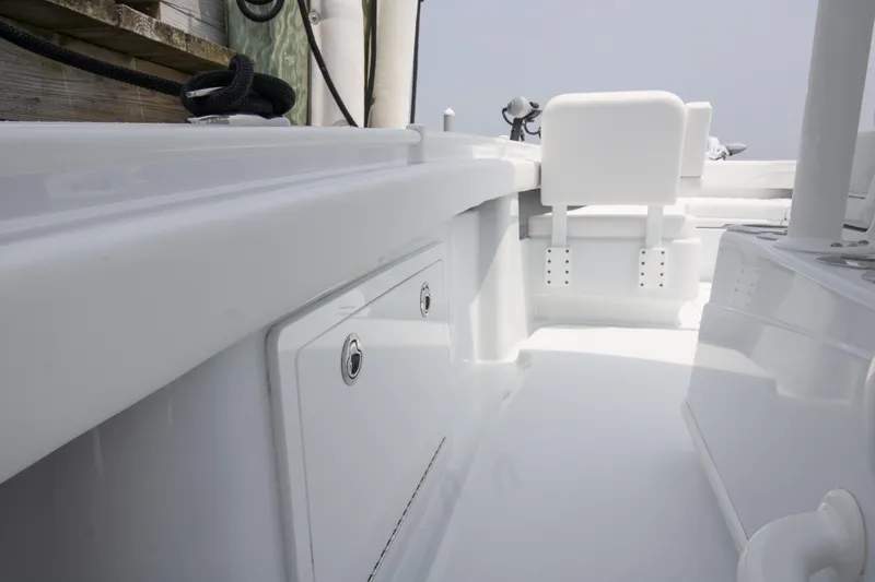  Yacht Photos Pics 2025 Yellowfin 26 Hybrid boat interior, showcasing sleek white design and storage compartments.