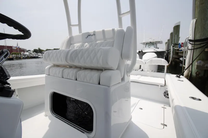  Yacht Photos Pics 2025 Yellowfin 26 Hybrid boat interior with white cushioned seating and storage compartment.
