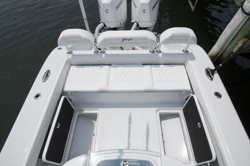  Yacht Photos Pics 2025 Yellowfin 26 Hybrid boat with white seating and storage compartments.