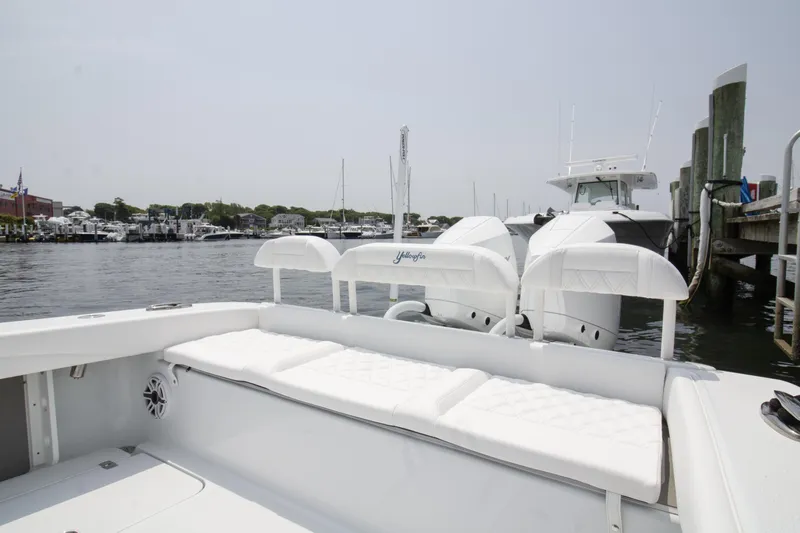  Yacht Photos Pics 2025 Yellowfin 26 Hybrid boat docked at marina, featuring spacious seating and twin engines.