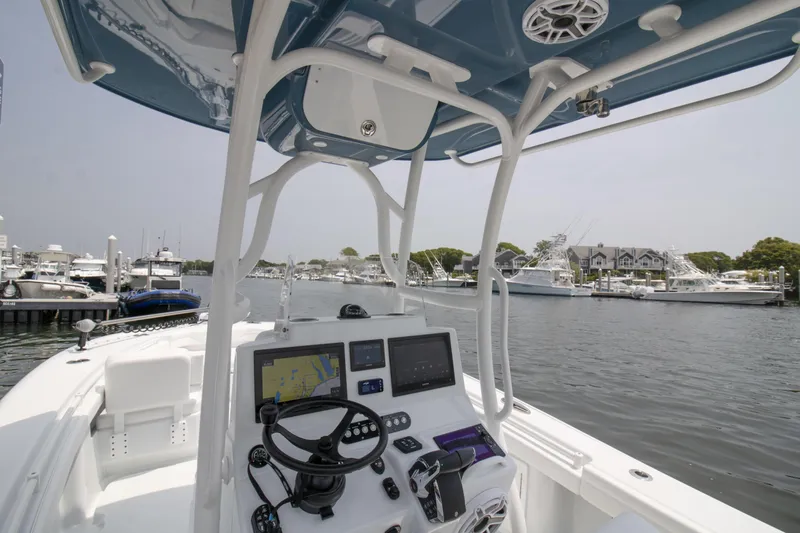  Yacht Photos Pics 2025 Yellowfin 26 Hybrid boat interior with navigation equipment, docked at a marina.