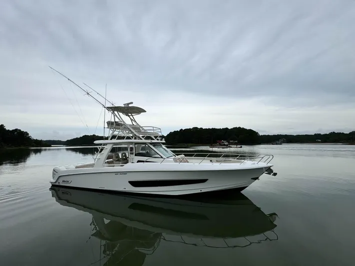 Seas The Day Yacht Photos Pics 2017 Boston Whaler 420 Outrage boat on calm water, overcast sky.