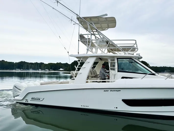 Seas The Day Yacht Photos Pics 2017 Boston Whaler 420 Outrage boat cruising on calm water.