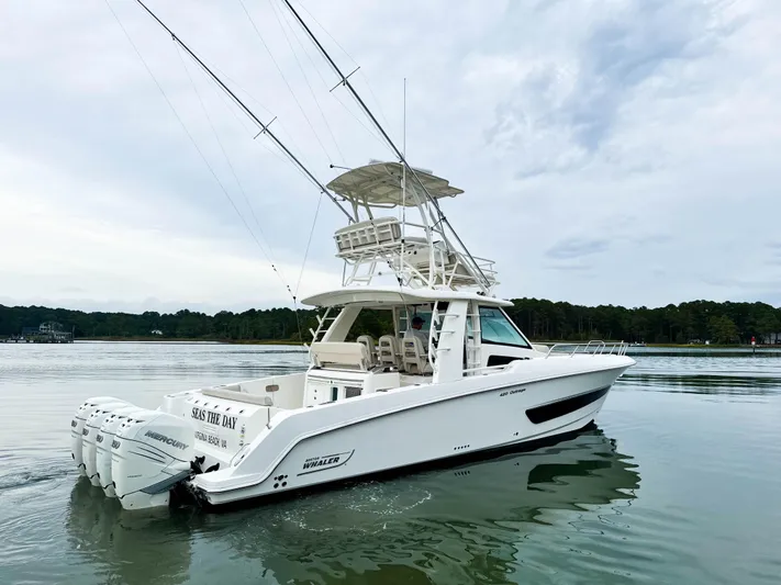 Seas The Day Yacht Photos Pics 2017 Boston Whaler 420 Outrage boat on calm water, featuring multiple outboard engines.