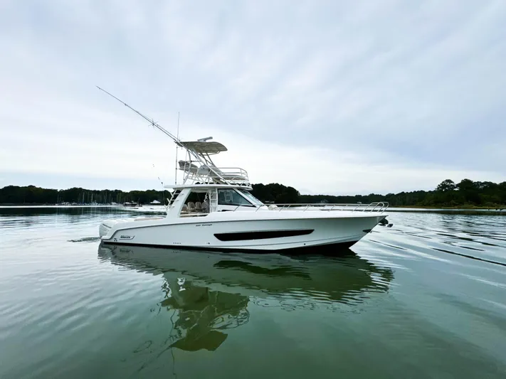 Seas The Day Yacht Photos Pics 2017 Boston Whaler 420 Outrage boat on calm water, side view.