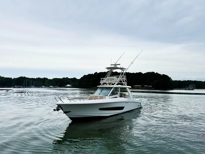 Seas The Day Yacht Photos Pics 2017 Boston Whaler 420 Outrage boat on calm water under cloudy sky.