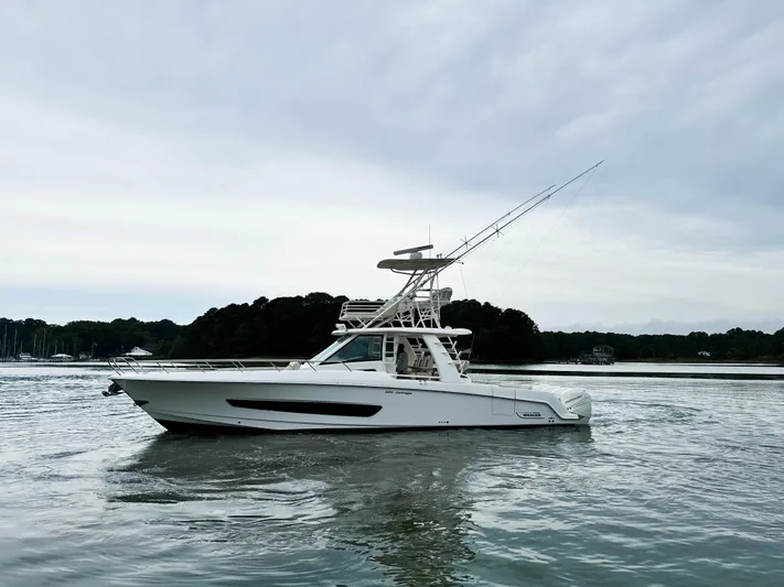 Seas The Day Yacht Photos Pics 2017 Boston Whaler 420 Outrage boat on calm water, overcast sky.