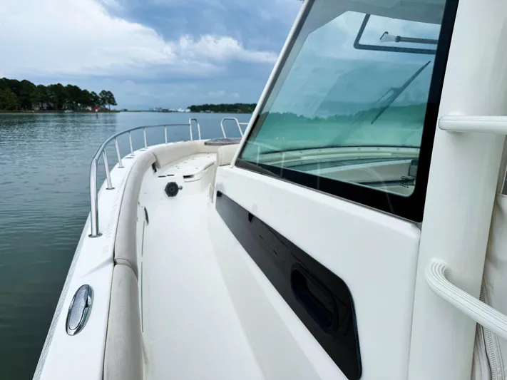 Seas The Day Yacht Photos Pics 2017 Boston Whaler 420 Outrage boat on calm water under cloudy sky.