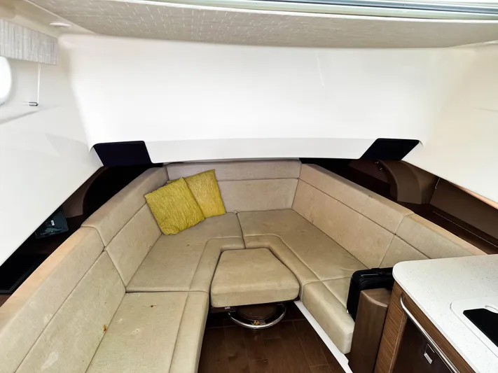 Seas The Day Yacht Photos Pics Interior of 2017 Boston Whaler 420 Outrage with beige seating and yellow cushion.