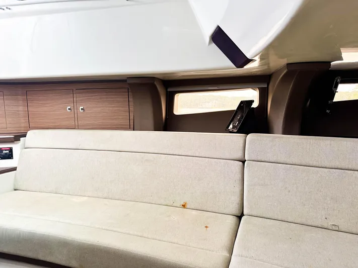 Seas The Day Yacht Photos Pics Interior of 2017 Boston Whaler 420 Outrage with beige seating and wooden cabinets.