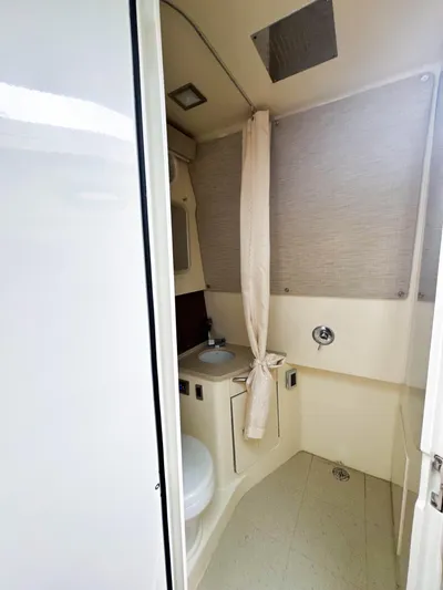 Seas The Day Yacht Photos Pics 2017 Boston Whaler 420 Outrage bathroom with shower, sink, and toilet.