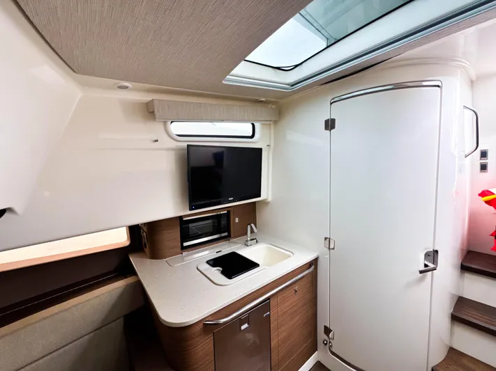 Seas The Day Yacht Photos Pics Interior of 2017 Boston Whaler 420 Outrage, featuring modern kitchenette and sleek design.