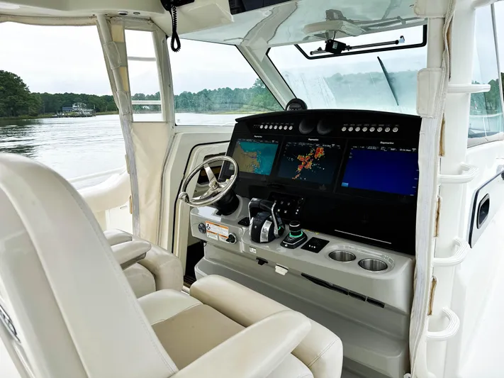 Seas The Day Yacht Photos Pics 2017 Boston Whaler 420 Outrage helm with advanced navigation displays and comfortable seating.