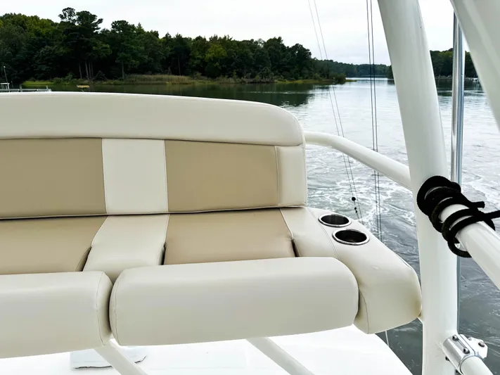 Seas The Day Yacht Photos Pics Boston Whaler 420 Outrage 2017 boat seat with cup holders on a calm river.