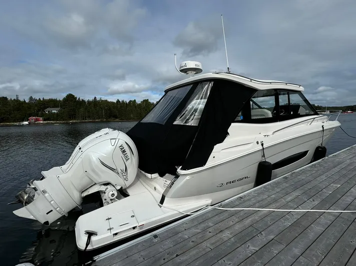 Harley Quinn Yacht Photos Pics 2023 Regal 36 XO boat docked, featuring Yamaha outboard engines, sleek design, and modern amenities.