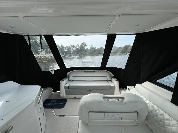 Harley Quinn Yacht Photos Pics Interior of 2023 Regal 36 XO yacht with luxurious seating and scenic water view.