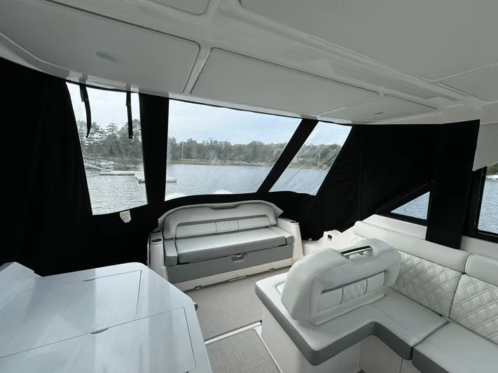 Harley Quinn Yacht Photos Pics 2023 Regal 36 XO yacht interior with luxurious seating and panoramic windows.