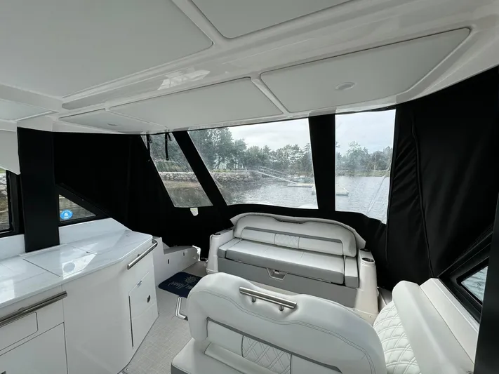 Harley Quinn Yacht Photos Pics Interior of 2023 Regal 36 XO yacht with modern seating and panoramic windows.