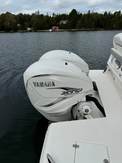 Harley Quinn Yacht Photos Pics 2023 Regal 36 XO boat with Yamaha XTO outboard engines on a calm lake.
