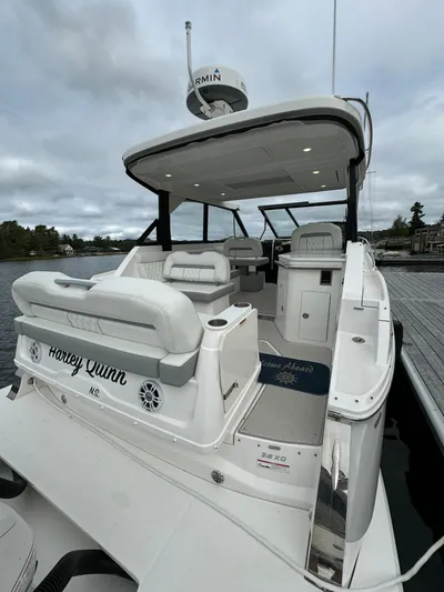 Harley Quinn Yacht Photos Pics 2023 Regal 36 XO luxury boat docked, featuring spacious seating and modern design.