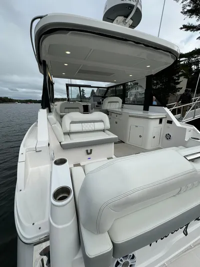 Harley Quinn Yacht Photos Pics 2023 Regal 36 XO luxury boat with spacious seating and modern amenities.