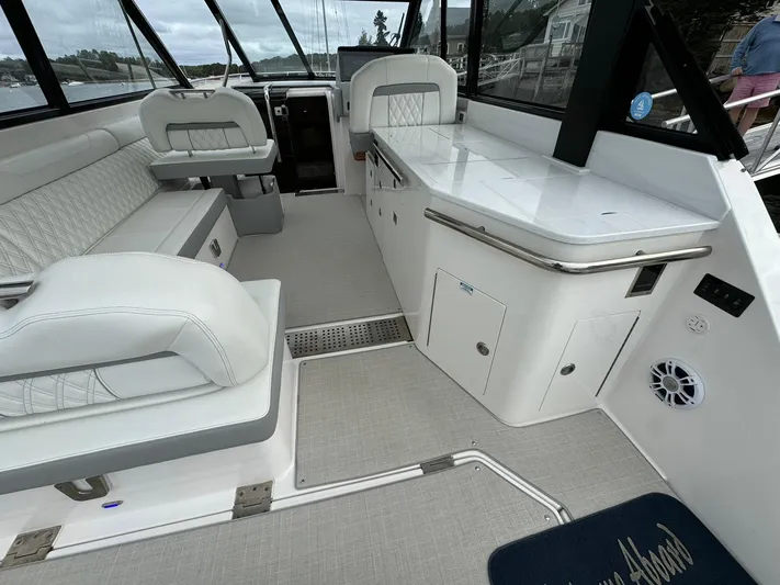 Harley Quinn Yacht Photos Pics 2023 Regal 36 XO boat interior with white seating and sleek design.