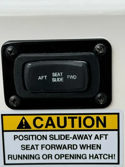 Harley Quinn Yacht Photos Pics Caution label and seat slide control on 2023 Regal 36 XO boat.