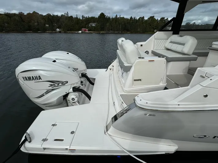 Harley Quinn Yacht Photos Pics 2023 Regal 36 XO boat with Yamaha outboard engines on a calm lake.