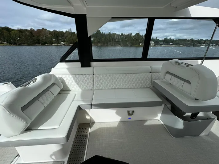 Harley Quinn Yacht Photos Pics Luxurious seating area on 2023 Regal 36 XO yacht with scenic water view.