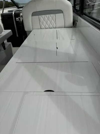 Harley Quinn Yacht Photos Pics 2023 Regal 36 XO boat interior with sleek seating and table design.