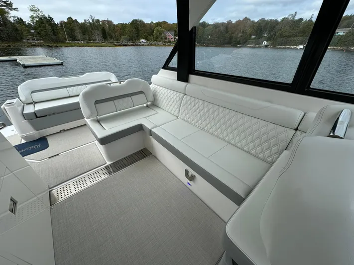 Harley Quinn Yacht Photos Pics 2023 Regal 36 XO boat interior with luxurious seating and scenic lake view.