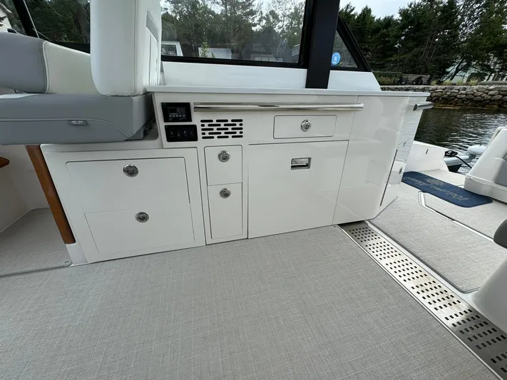 Harley Quinn Yacht Photos Pics 2023 Regal 36 XO boat interior with sleek cabinetry and modern design.