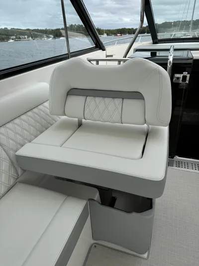 Harley Quinn Yacht Photos Pics 2023 Regal 36 XO boat interior with luxurious white seating and quilted design.