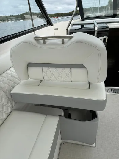 Harley Quinn Yacht Photos Pics 2023 Regal 36 XO boat interior with white leather seating and elegant stitching.