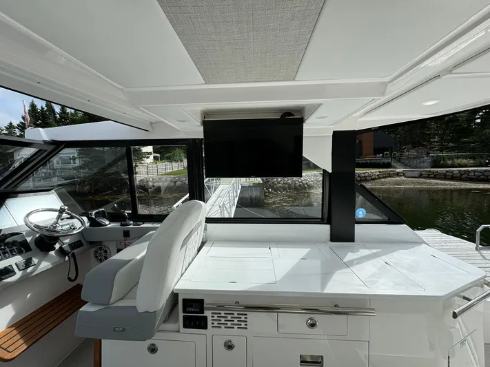 Harley Quinn Yacht Photos Pics Interior of 2023 Regal 36 XO yacht with modern helm and seating area.